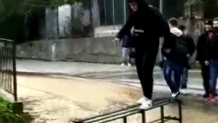 video fiume d acqua davanti scuola studenti improvvisano passerella